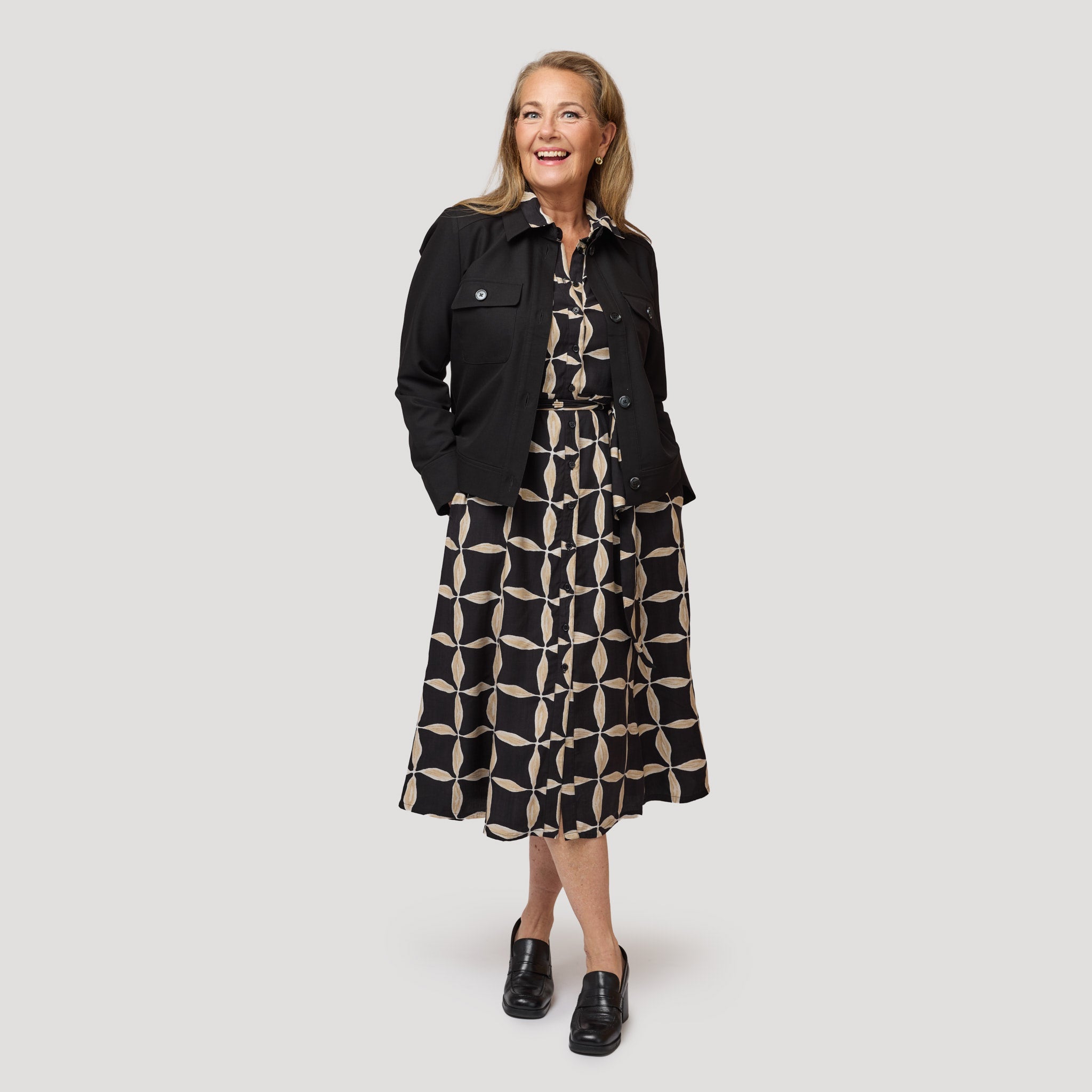 Skjortklänning under en svart jacka